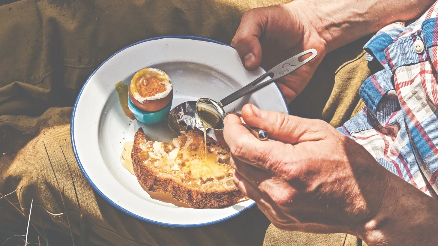 Nestling eggs in campfire ashes is a low-fi way to prepare a camping breakfast in minutes.