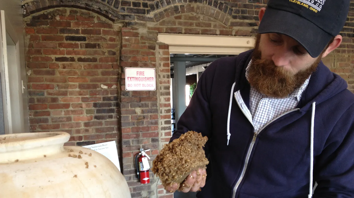 Tate Paulette adds bappir to a fermentation vessel while trying to replicate an ancient beer.