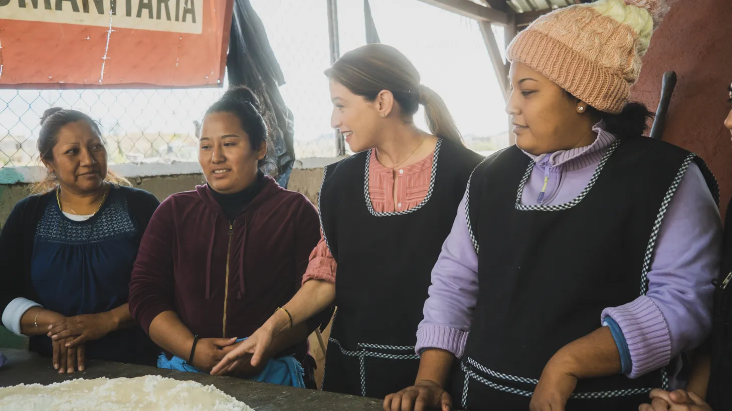 Pati Jinich bakes bread with women at a migrant shelter in the series "La Frontera," which documents the US and Mexico's cross-border culture.