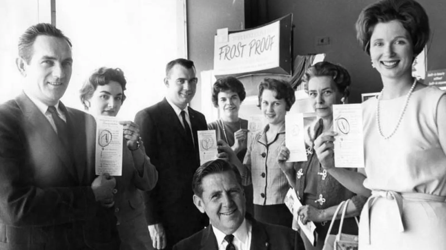 Roy Rick, owner of Rick's Appliances in Burbank (center), smiles alongside other winners of a Frigidaire campaign, c. 1963.
