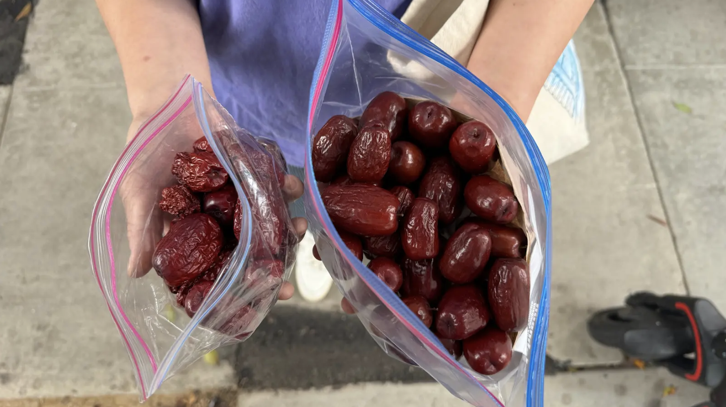 Klementine Song holds dried jujubes (left) and freshly harvested fruit (right).