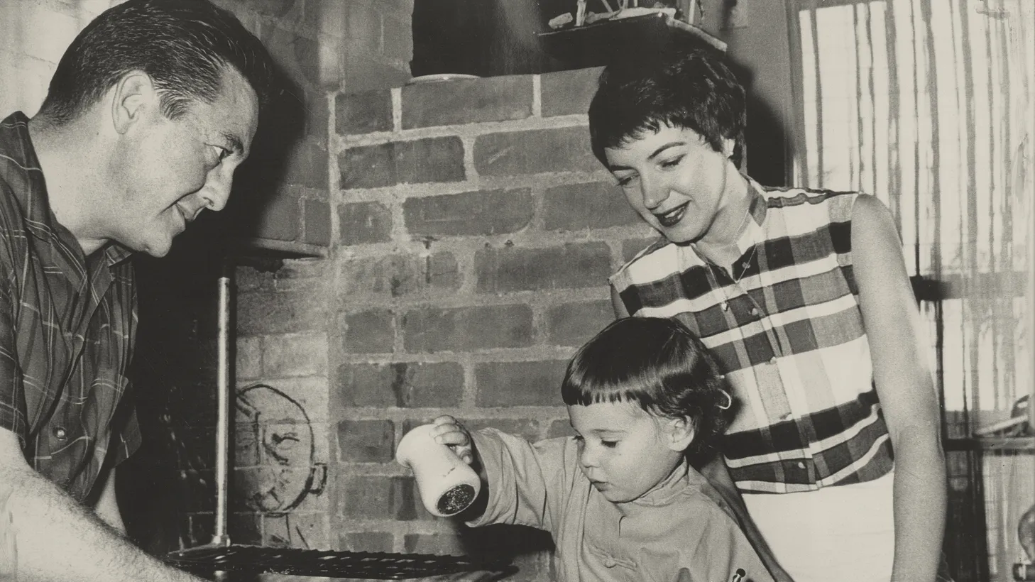 Flanked by her parents, actor Edward Binns and journalist Marcia Legere Binns, the author salts a steak in a photo for TV Guide.