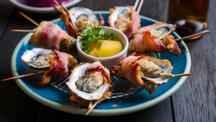 From ceviche and salmon salad, to basil-grilled tuna and bacon BBQ oysters — seafood is a scrumptious summer option.