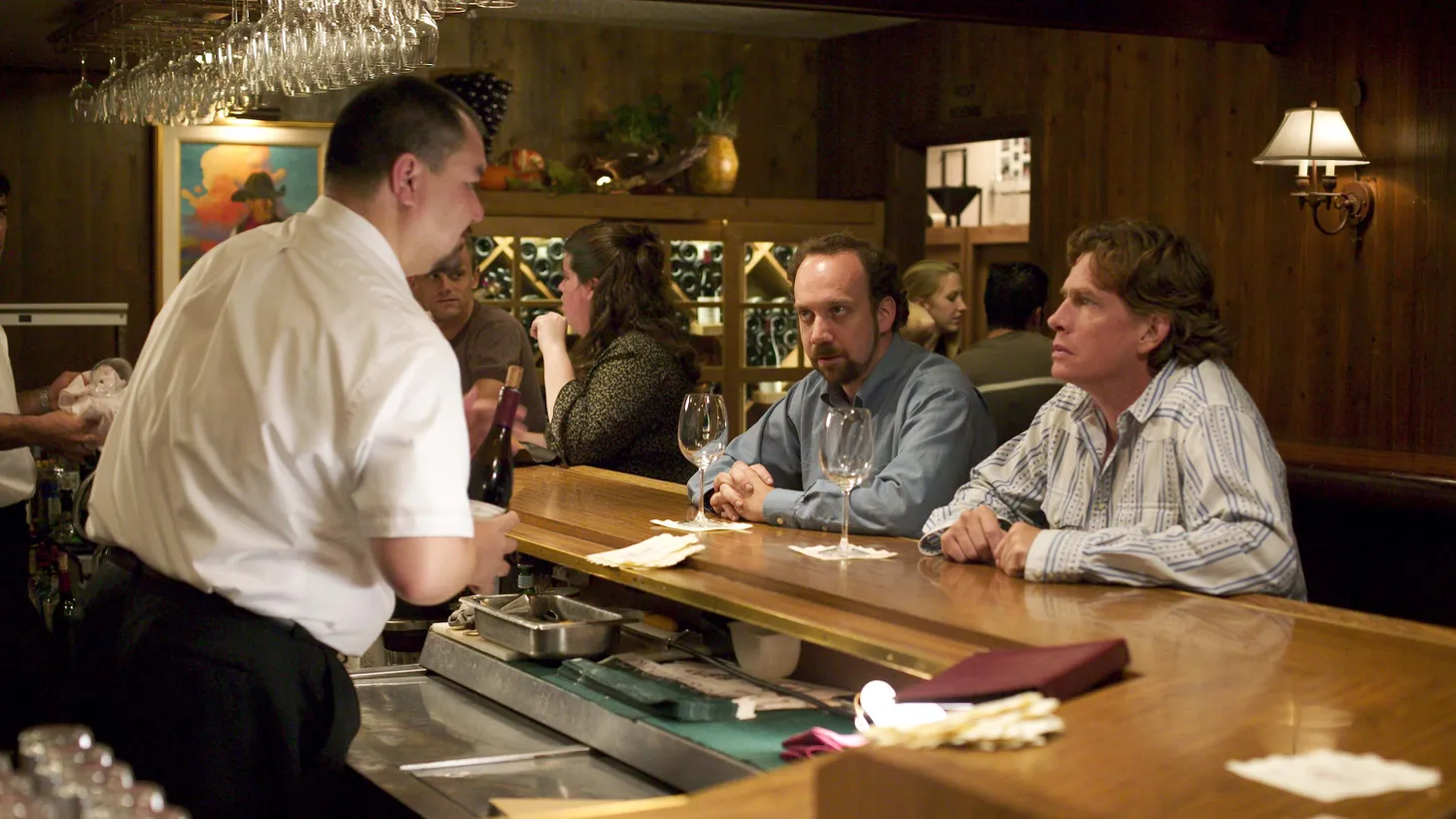 Paul Giamatti (center) and Thomas Hayden Church (right) sit at the Hitching Post bar in a scene from "Sideways."