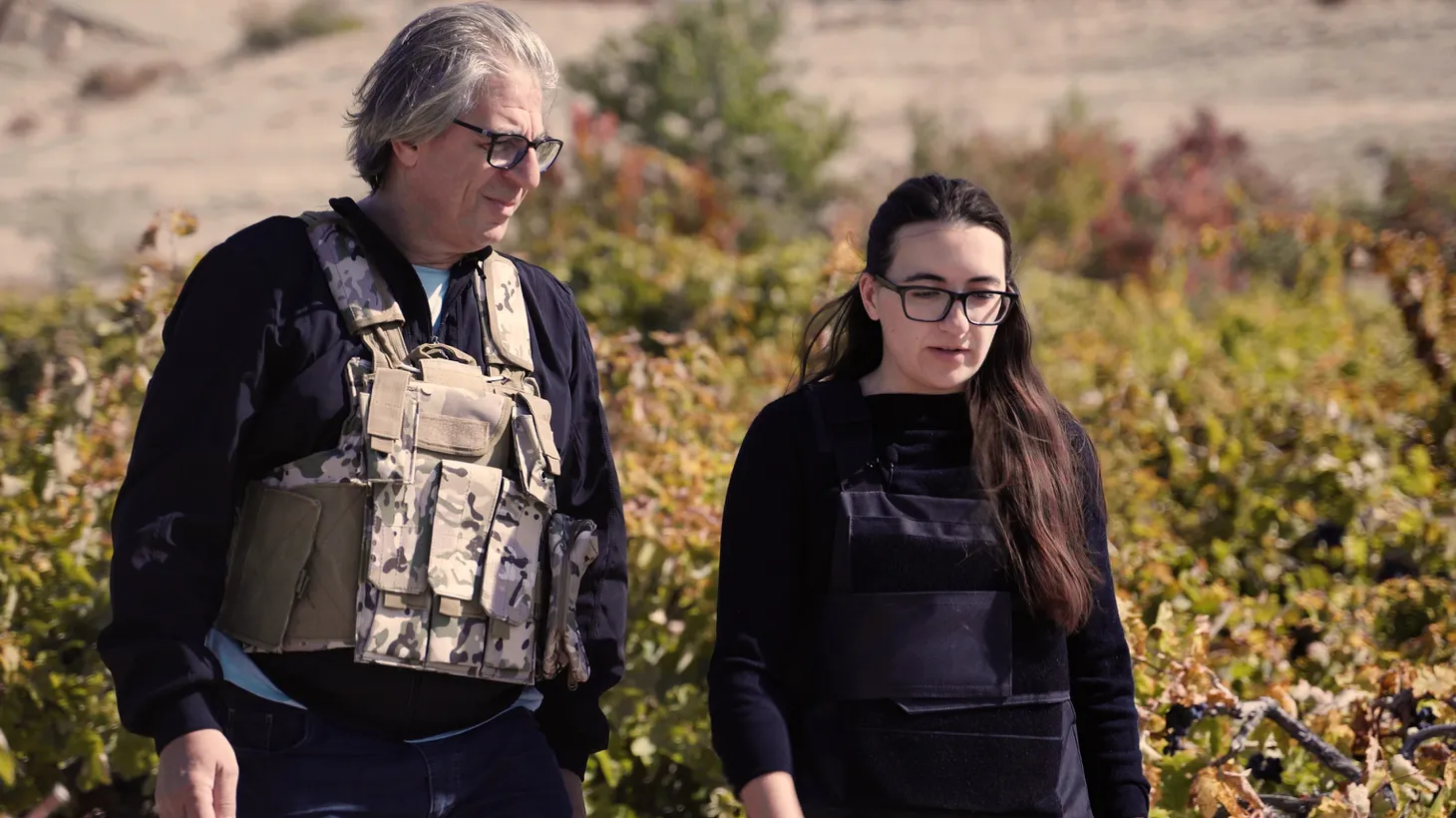 Vahe Keushguerian (left) and his daughter, Aimee, wear bulletproof vests as they harvest grapes on the border of Armenia and Azerbaijan.