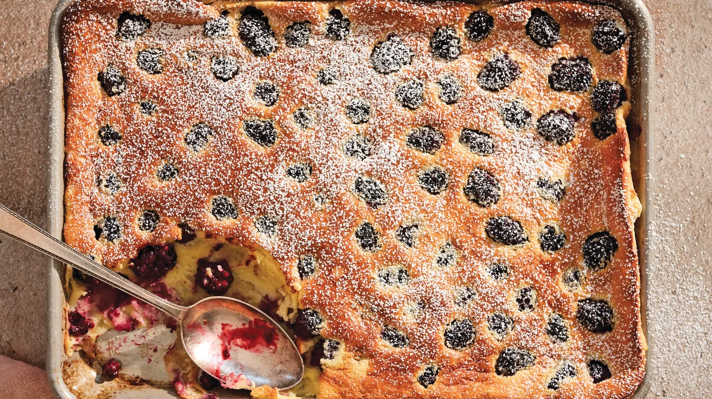 Blackberry-lemon clafoutis baked in a sheet pan makes for a quick and easy dessert.