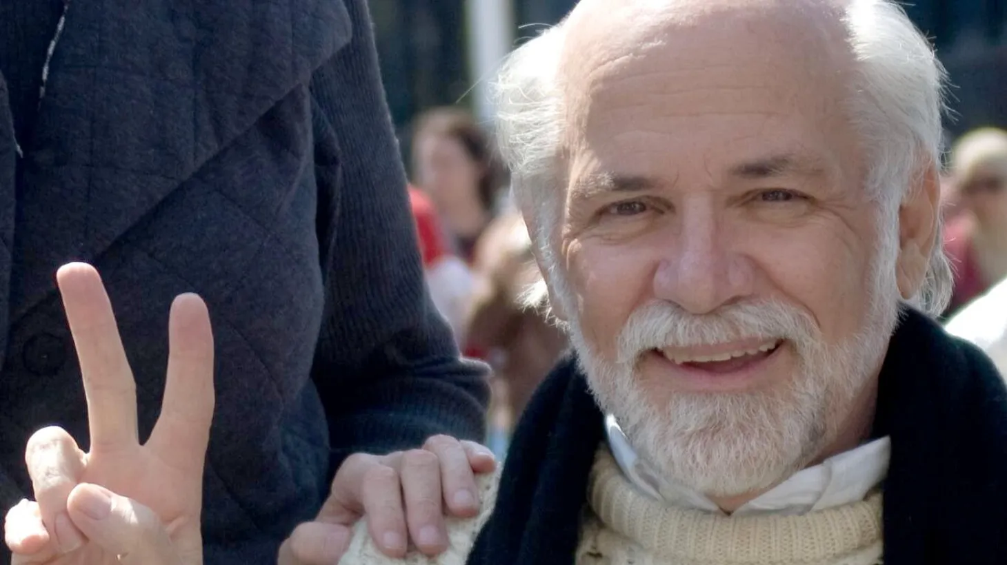 Ron Kovic Flashes a peace sign.