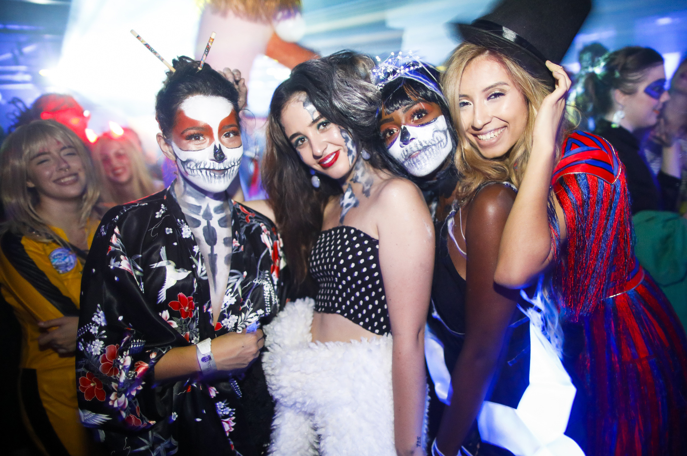 Five costumed women dressed variously in Día de los Muertos makeup, as Beatrix Kiddo from Kill Bill, and generally festive/spooky clothing