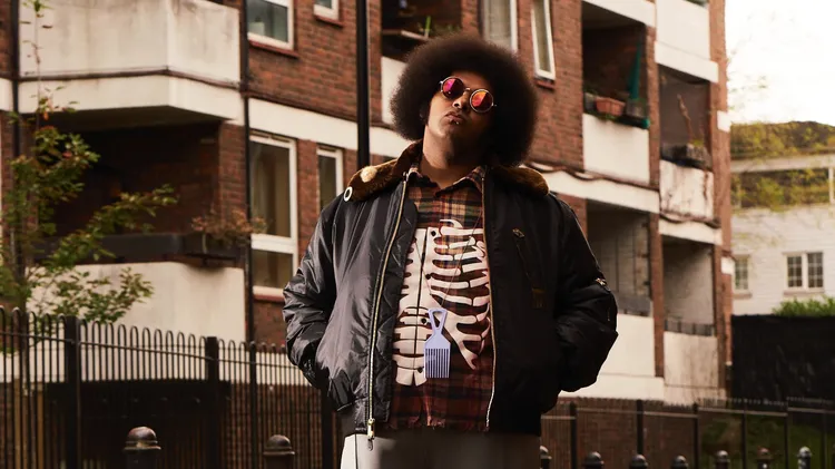 Let’s call him a polymath, cause these are just a few of the skills he’s aced: singing, rapping, playing bass and producing music… It's Dylan Cartlidge whose song “New Day” is a…