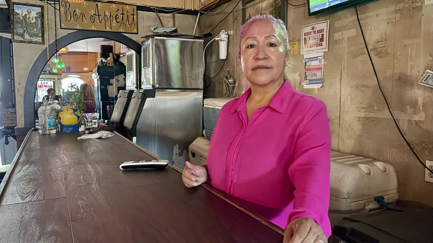 Rosa Garcia stands at the bar of her Boyle Heights restaurant El Apetito. Her landlord hopes to demolish the building.