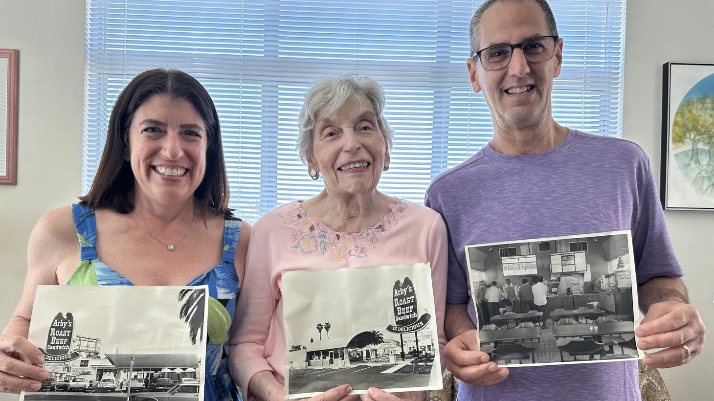 L to R: Debby Husch, Marilyn Leviton, and Gary Husch — longtime owners of the recently closed landmark Arby’s restaurant on Sunset Blvd. — pose with photos of their family business.