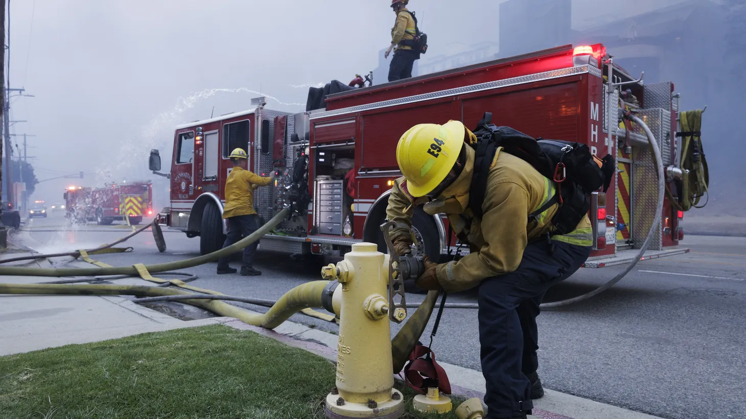 A CalFire firefighter opens up a hydrant to defend buildings from the rapidly spreading Palisades Fire in Pacific Palisades neighborhood of Los Angeles, Calif., on Tuesday, Jan. 7, 2025.