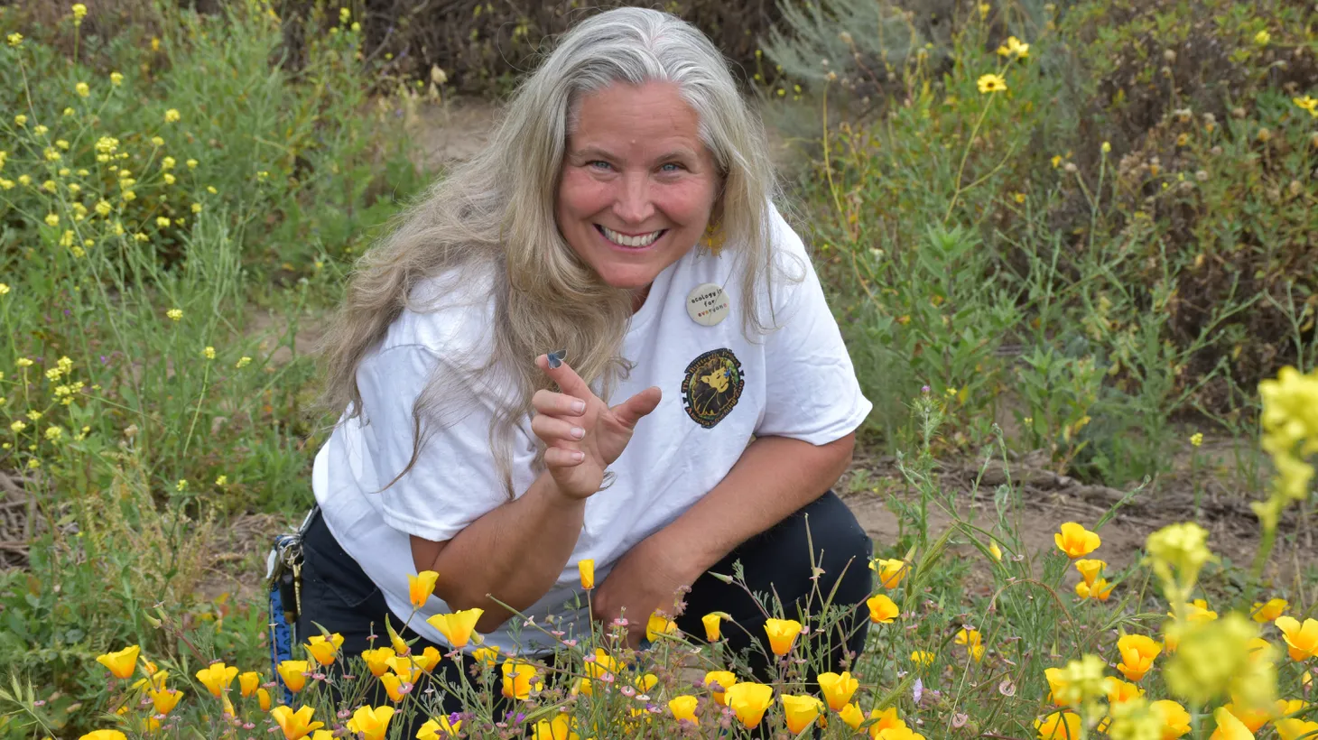 Jana Johnson of Moorpark College’s Butterfly Project poses with a Palos Verdes blue butterfly during a spring 2024 release at a Rolling Hills Estates reserve.