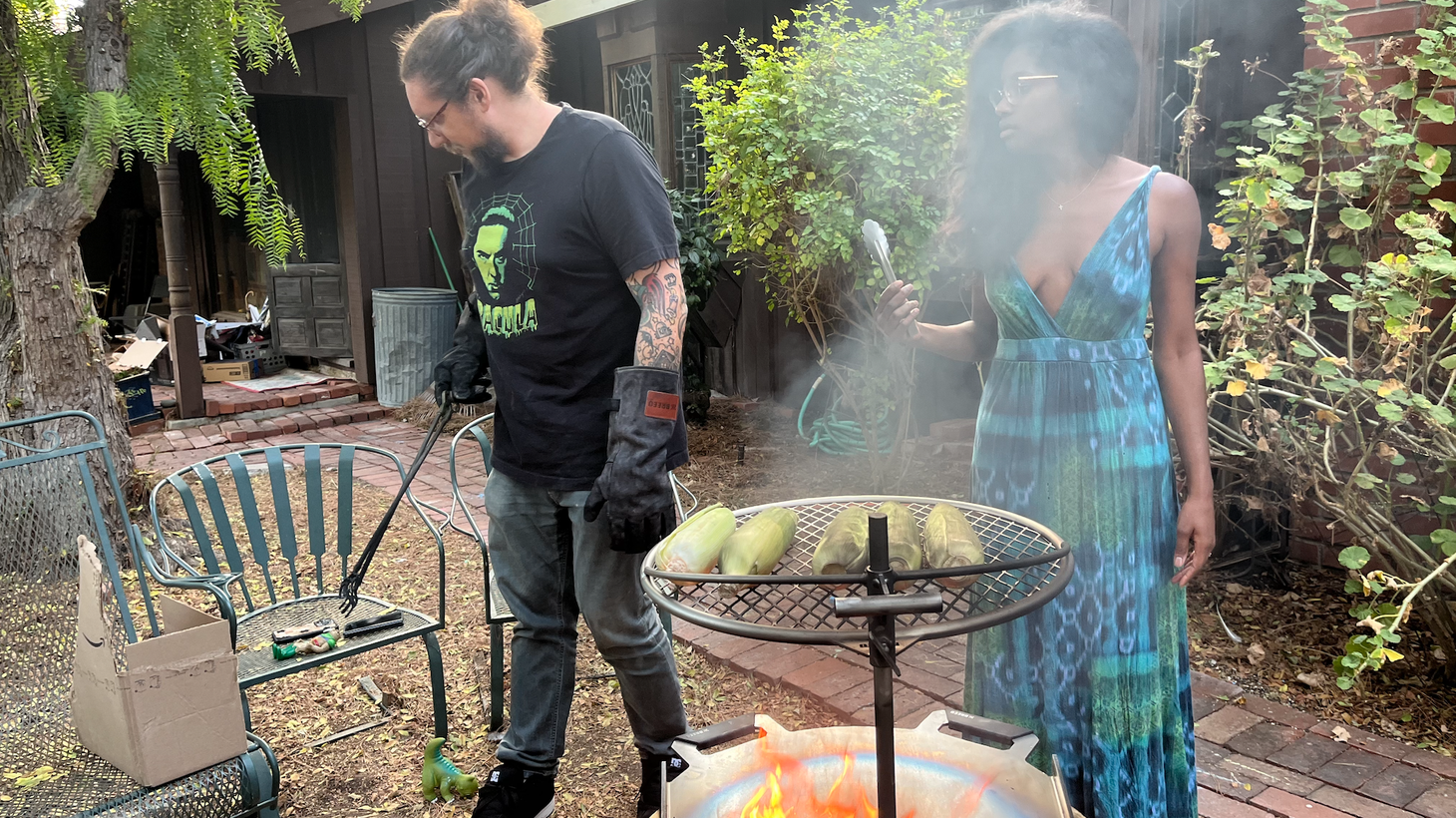 Portuguese Bend residents Eric and Anissa Ehlenberger prepare dinner outside with a new barbecue pit. The houses on their street have not suffered landslide damage, but still have no electricity, gas, or cable.