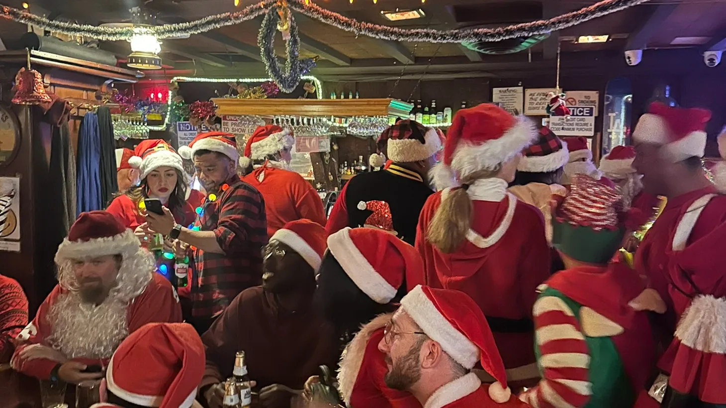 Dozens of Santas pack into the HMS Bounty bar in Koreatown for LA’s annual SantaCon.