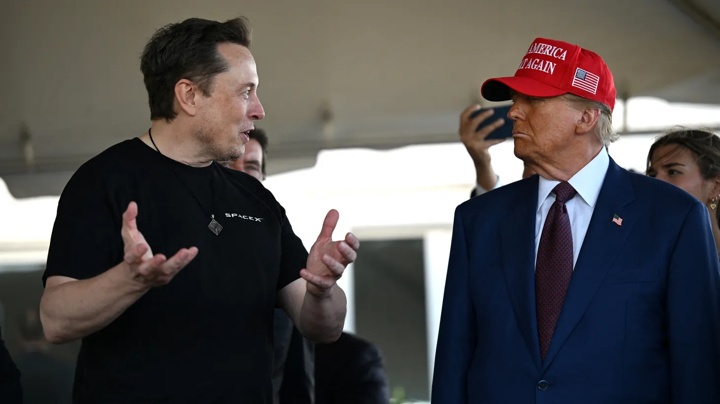 Elon Musk (left) speaks with President-elect Donald Trump (right) at a SpaceX launch viewing on November 19, 2024.