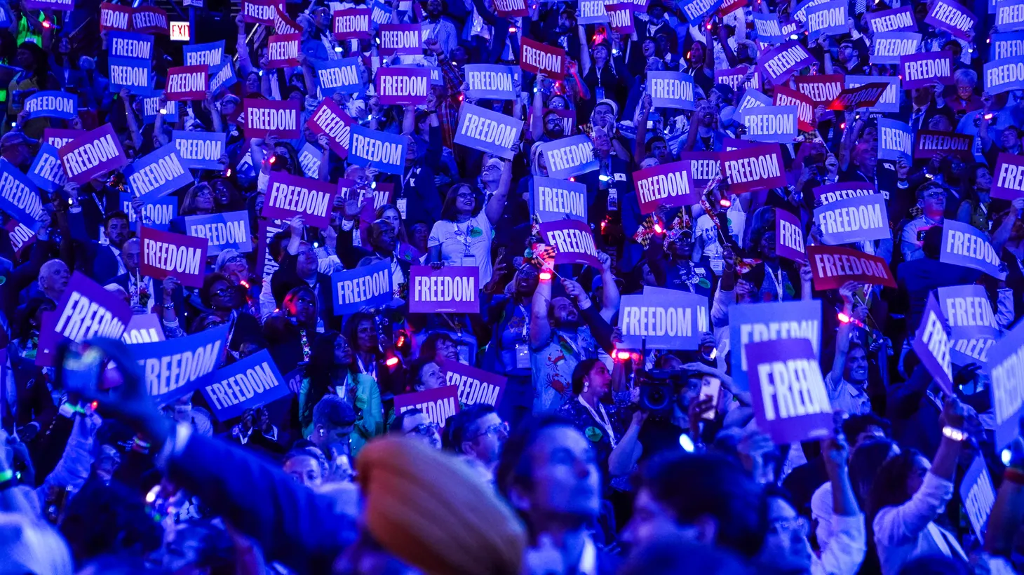 People in the audience hold “freedom” signs on day two of the Democratic National Convention in Chicago, Illinois on August 20, 2024.