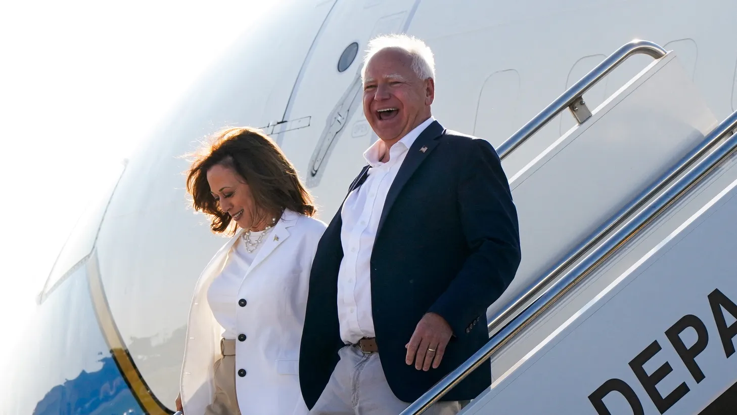 Kamala Harris and her newly-chosen vice presidential running mate, Minnesota Governor Tim Walz, arrive at Detroit Metropolitan Wayne County Airport in Romulus, Michigan, U.S., August 7, 2024.