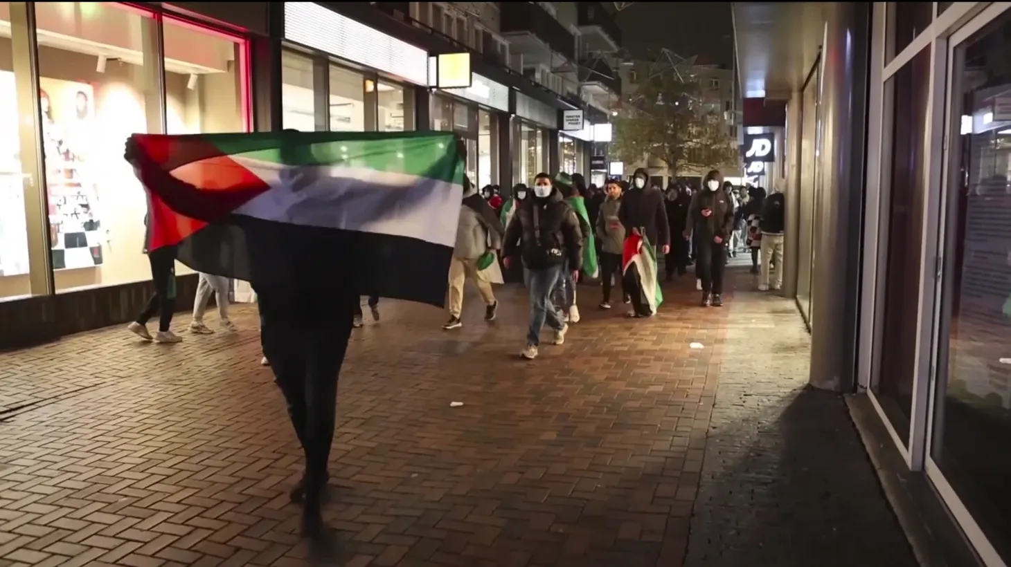 In this image taken from video, pro-Palestinian supporters march with Palestinian flags near the Ajax stadium in Amsterdam, the Netherlands, Thursday, Nov. 7, 2024.