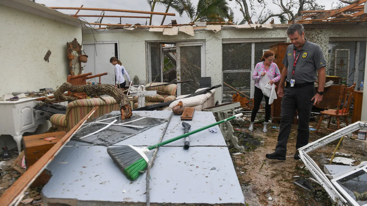 Mark Shaw, deputy chief with Indian River Shores Public Safety Department, checks on Bethel Creek resident Cary Yarema, Thursday, Oct. 10, 2024, who was in her home when an apparent tornado touched down and tore through the beachside community Wednesday during Hurricane Milton.