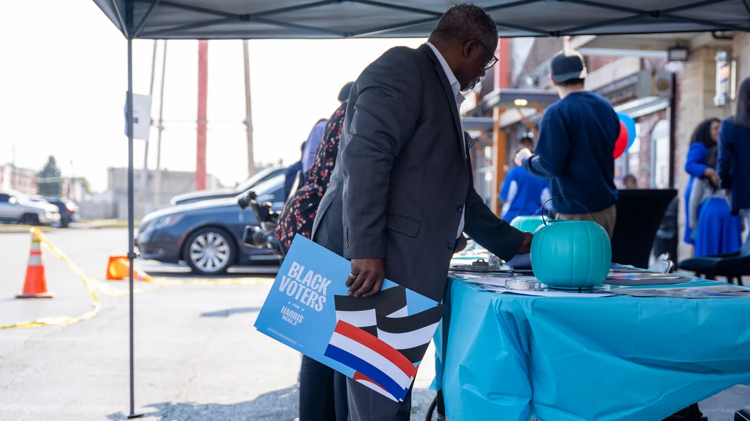 A man picks out Harris-Walz campaign posters at a campaign event in Philadelphia, Pennsylvania, United States, on October 13, 2024.