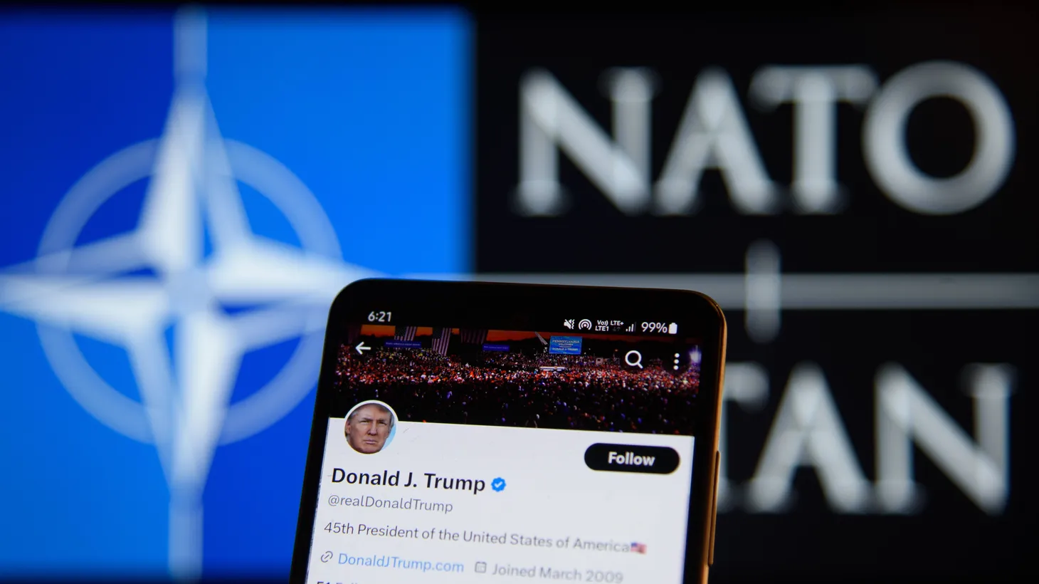 Donald Trump’s account on the social media platform X is pictured on a smartphone in front of a NATO logo on February 11, 2024 in Warsaw, Poland.