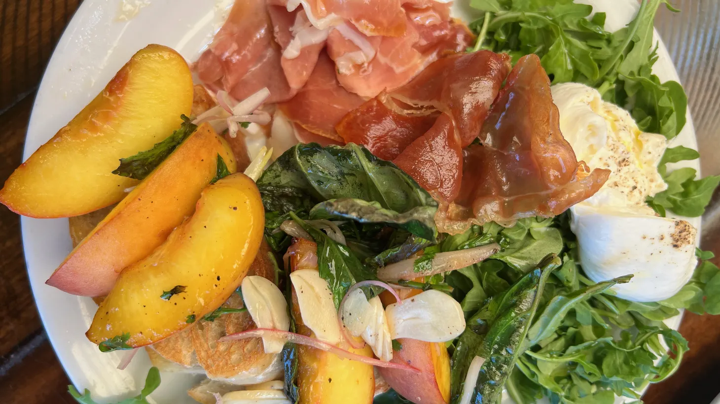 Grilled peach, prosciutto, and burrata compose a welcome summer salad plate at Industrial Eats in Buellton.