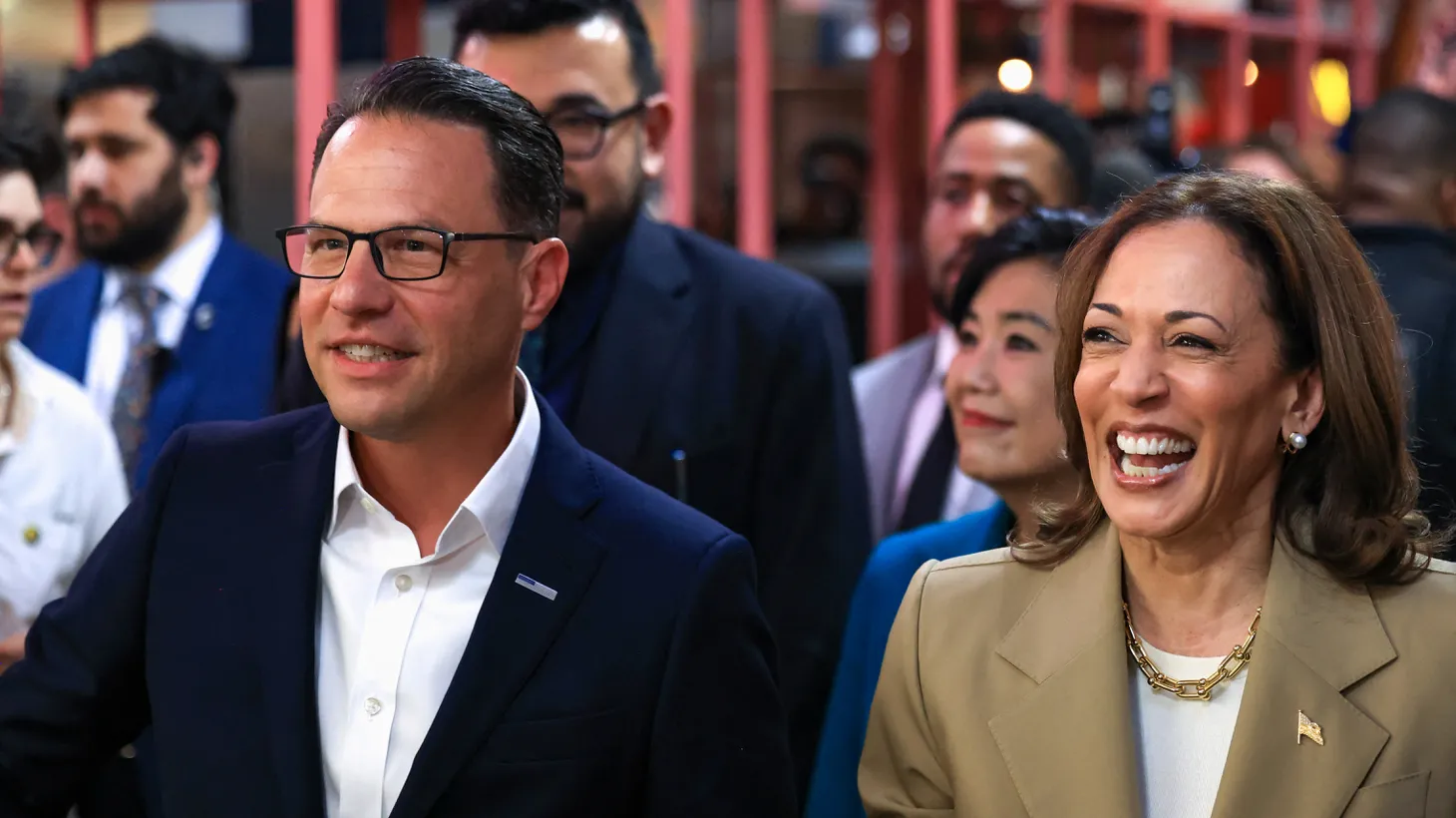 U.S. Vice President Kamala Harris and Pennsylvania Governor Josh Shapiro react during a visit to the Reading Terminal Market in Philadelphia, July 13, 2024.