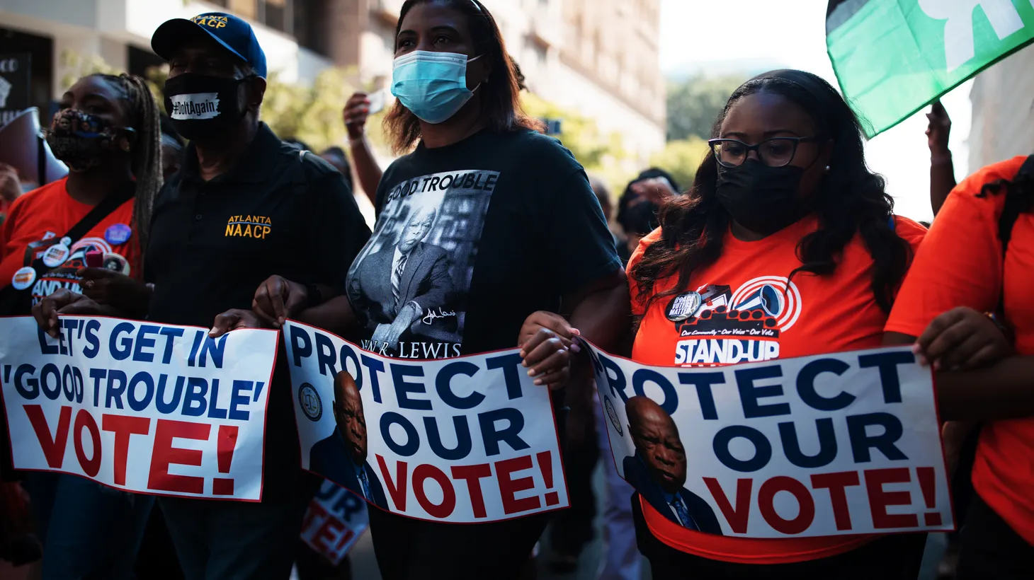 Activists carry signs that say, “Protect Our Vote,” during a march in Washington D.C., Aug 28, 2021.