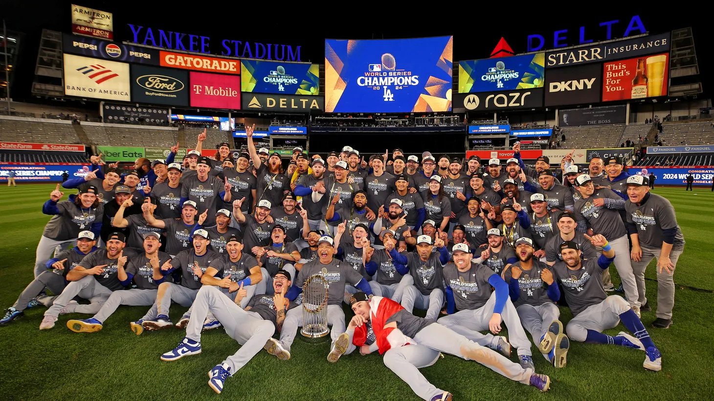 The Los Angeles Dodgers pose for a picture with the Commissioner’s Trophy after beating the New York Yankees to win the 2024 MLB World Series at Yankee Stadium, New York, USA, October 2024.