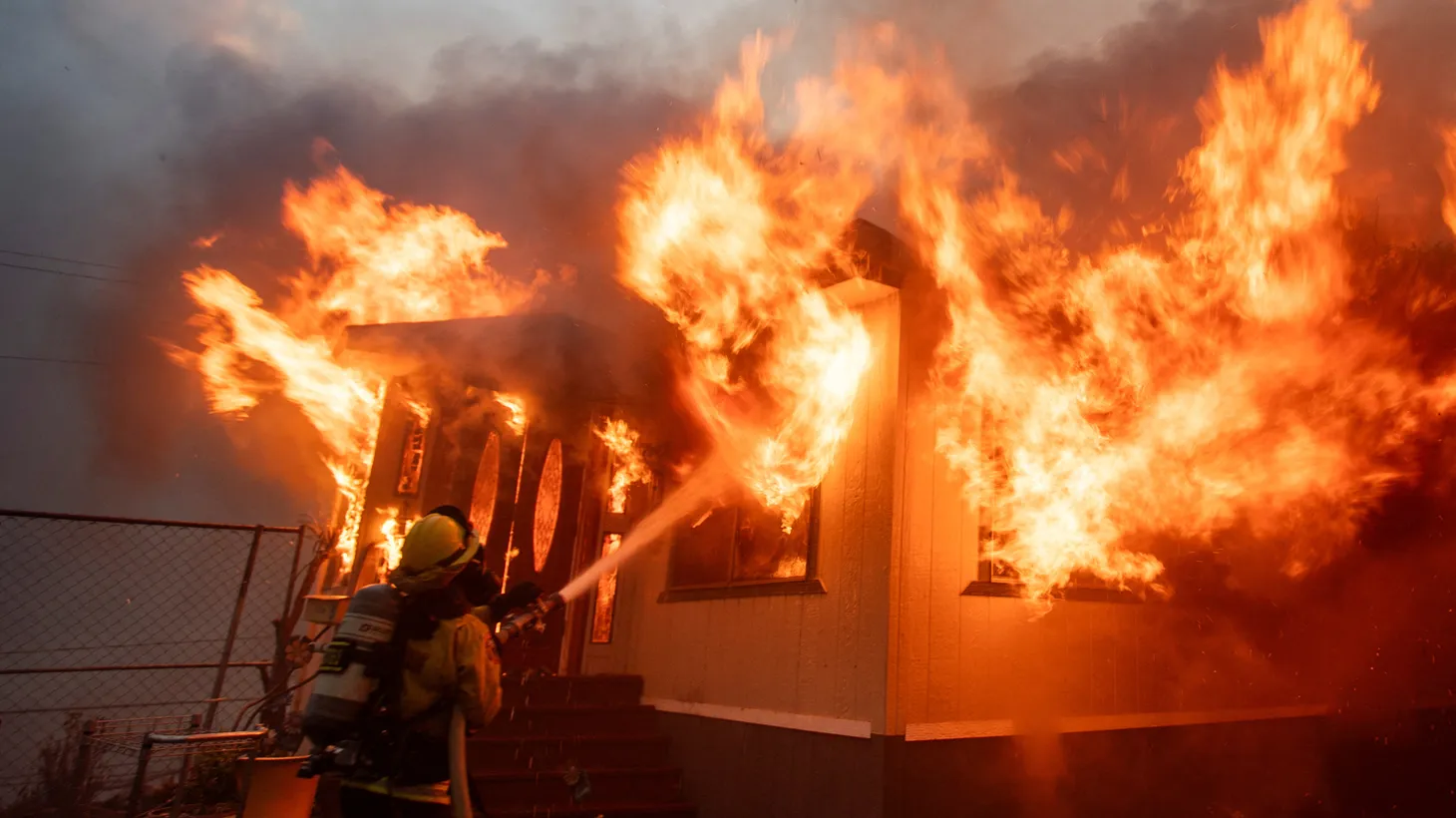 A firefighter battles the Palisades Fire as it burns during a windstorm on the west side of Los Angeles, California, U.S. January 7, 2025.