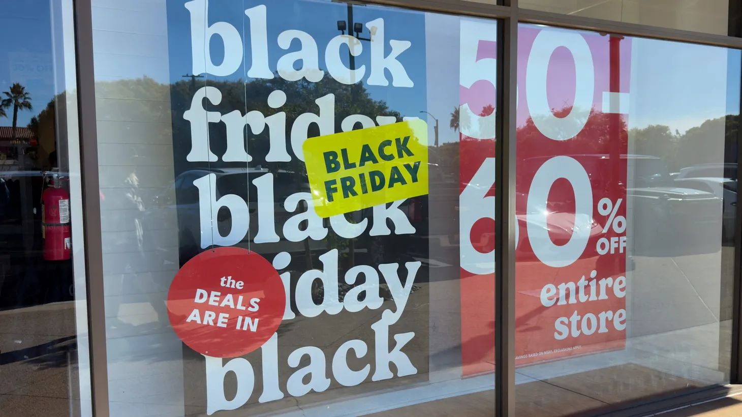 Black Friday sale signs are displayed at an outdoor shopping mall in Carlsbad, California, U.S., November, 25, 2024.